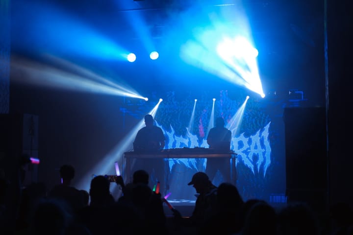 Nemurai on stage, silhouetted against the glitching Nemurai logo on the screen