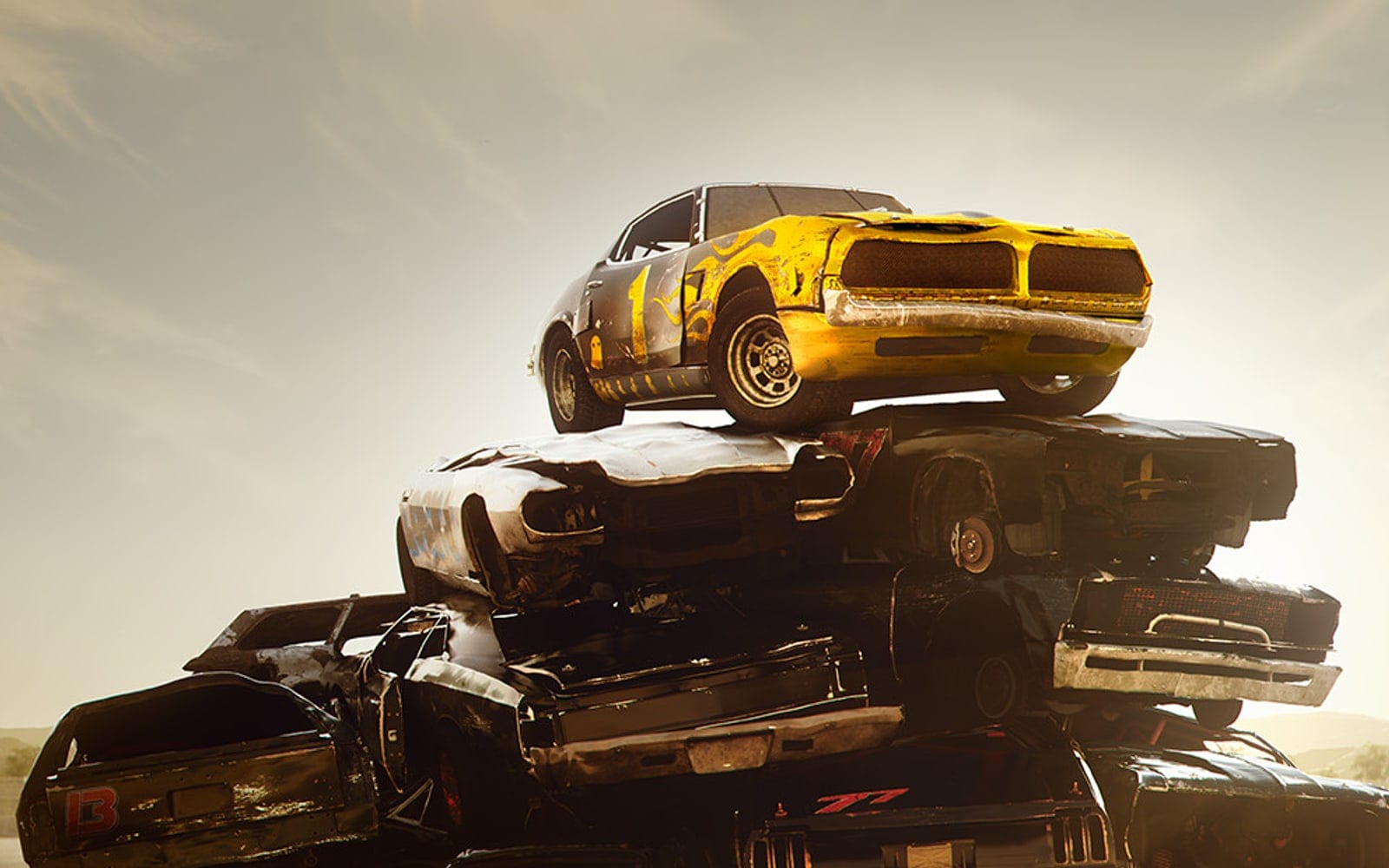 Wreckfest key art: a stack of wrecked cars at a race track